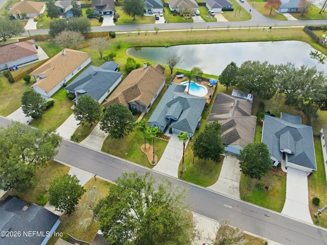 an aerial view of a house with a lake view