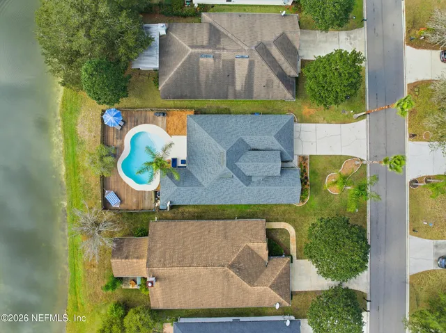 an aerial view of a house with a swimming pool
