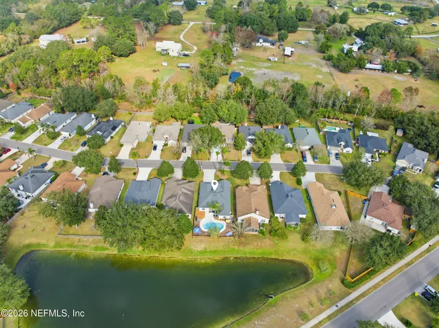 a view of residential houses with outdoor space and street view