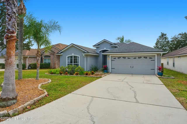 a front view of a house with a yard and garage