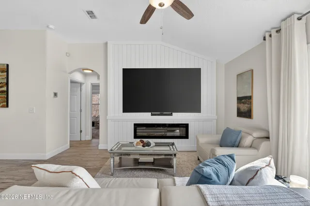a living room with furniture and a flat screen tv