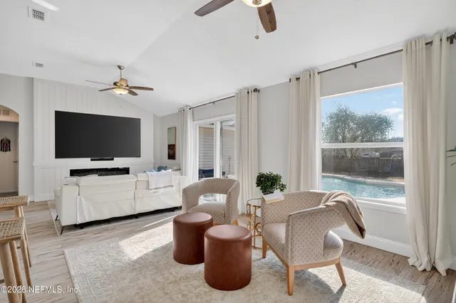 a living room with furniture and a flat screen tv