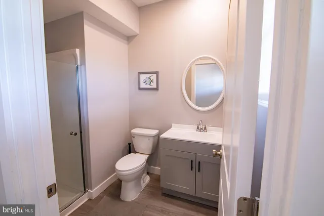 a bathroom with a toilet a sink and a mirror