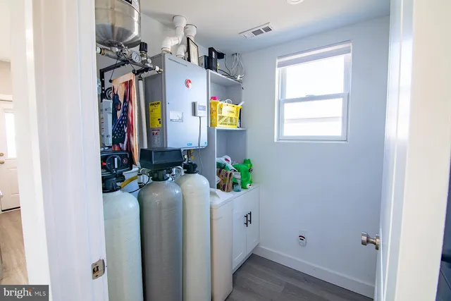 a room that has a mirror and dresser in it