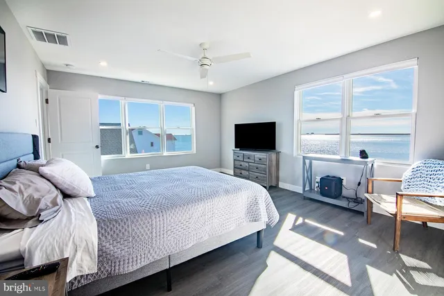 a bedroom with a bed and a flat tv screen