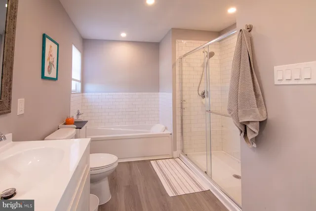 a bathroom with a toilet sink and shower