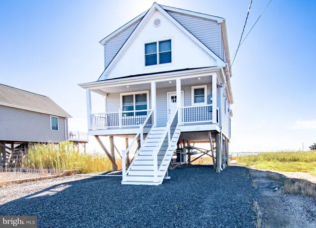 a view of a house with a yard and sitting area