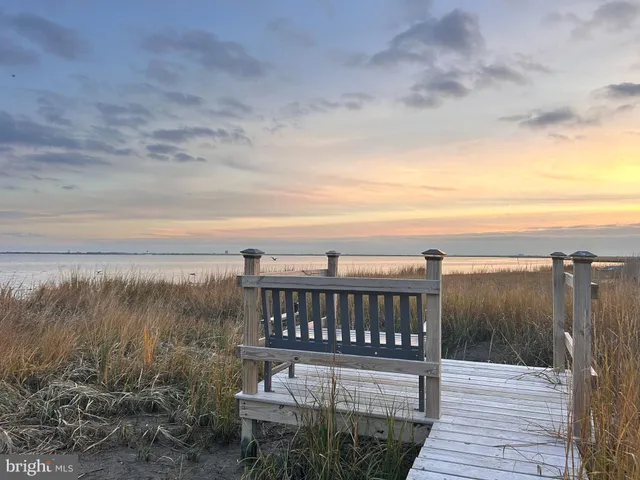 a view of a balcony with wooden floor and lake view