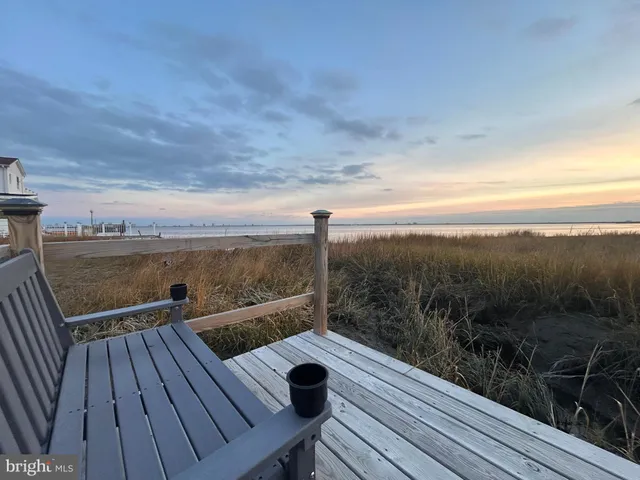 a view of roof deck with two chairs and wooden floor