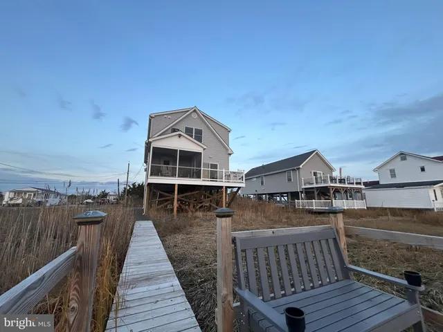 a view of a roof deck with table and chairs