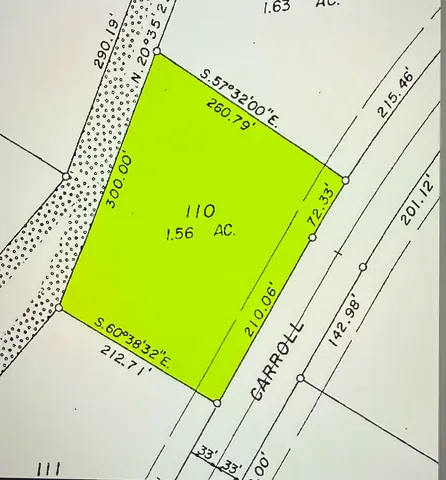 a green field with sitting area in the background