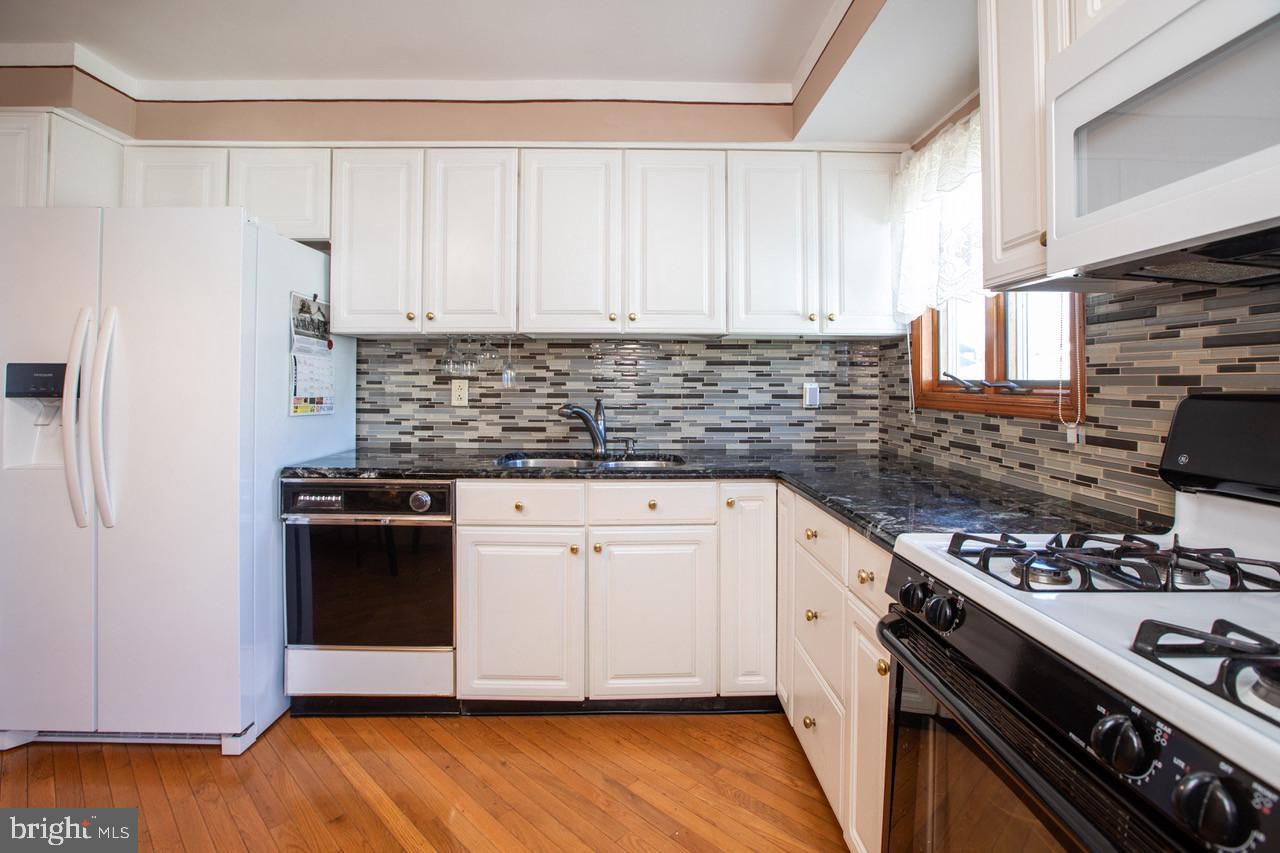 38 Albemarle Road Hamilton, NJ 08690 - Photo 13 of 39 a kitchen with stainless steel appliances white cabinets and a stove top oven