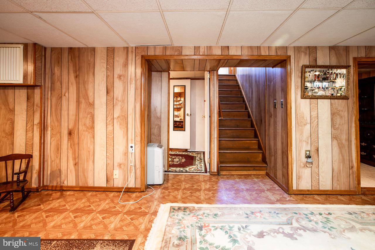 38 Albemarle Road Hamilton, NJ 08690 - Photo 25 of 39 an empty room with a fireplace and chandelier