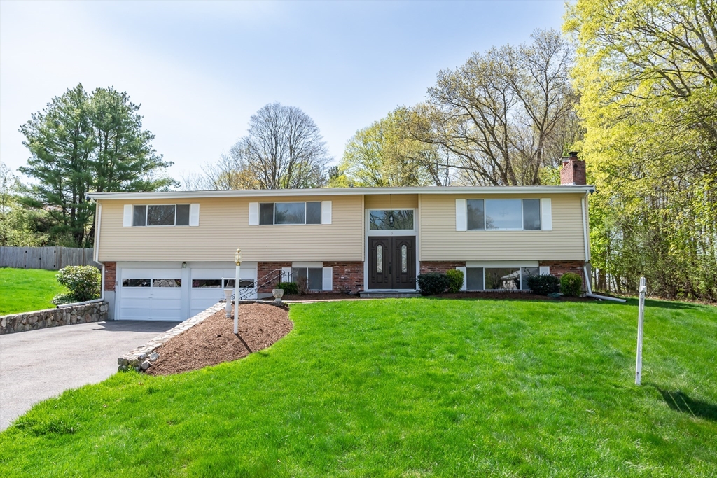 a view of a house with a yard and sitting area