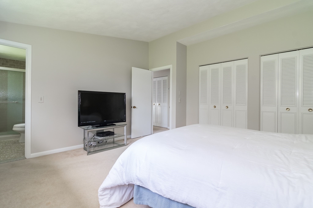 9 Clearview Drive Natick, MA 01760 - Photo 18 of 27 a bedroom with a bed and a flat tv screen on wall