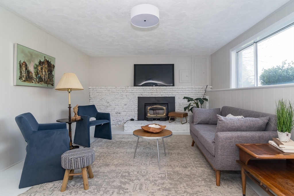 9 Clearview Drive Natick, MA 01760 - Photo 21 of 27 a living room with furniture a window and a fireplace