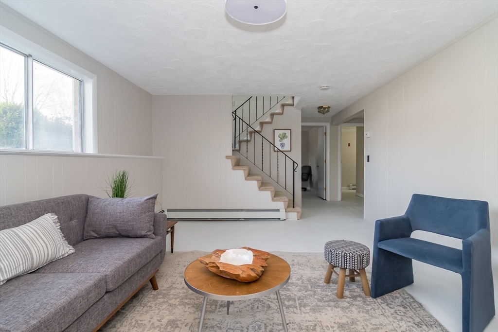 9 Clearview Drive Natick, MA 01760 - Photo 22 of 27 a living room with furniture and a potted plant