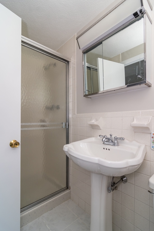 9 Clearview Drive Natick, MA 01760 - Photo 23 of 27 a bathroom with a sink and a mirror