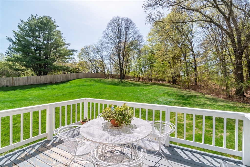 9 Clearview Drive Natick, MA 01760 - Photo 10 of 27 a view of a deck with a table and chairs