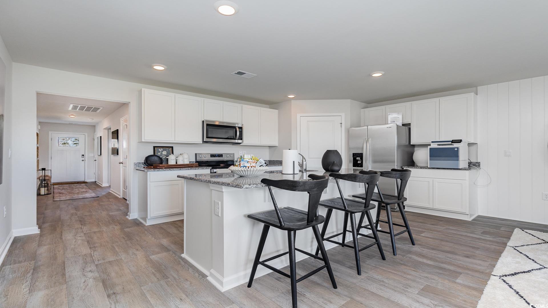 331 Acosta Circle Conway, SC 29527 - Photo 19 of 20 Kitchen with white cabinets, an island with sink,