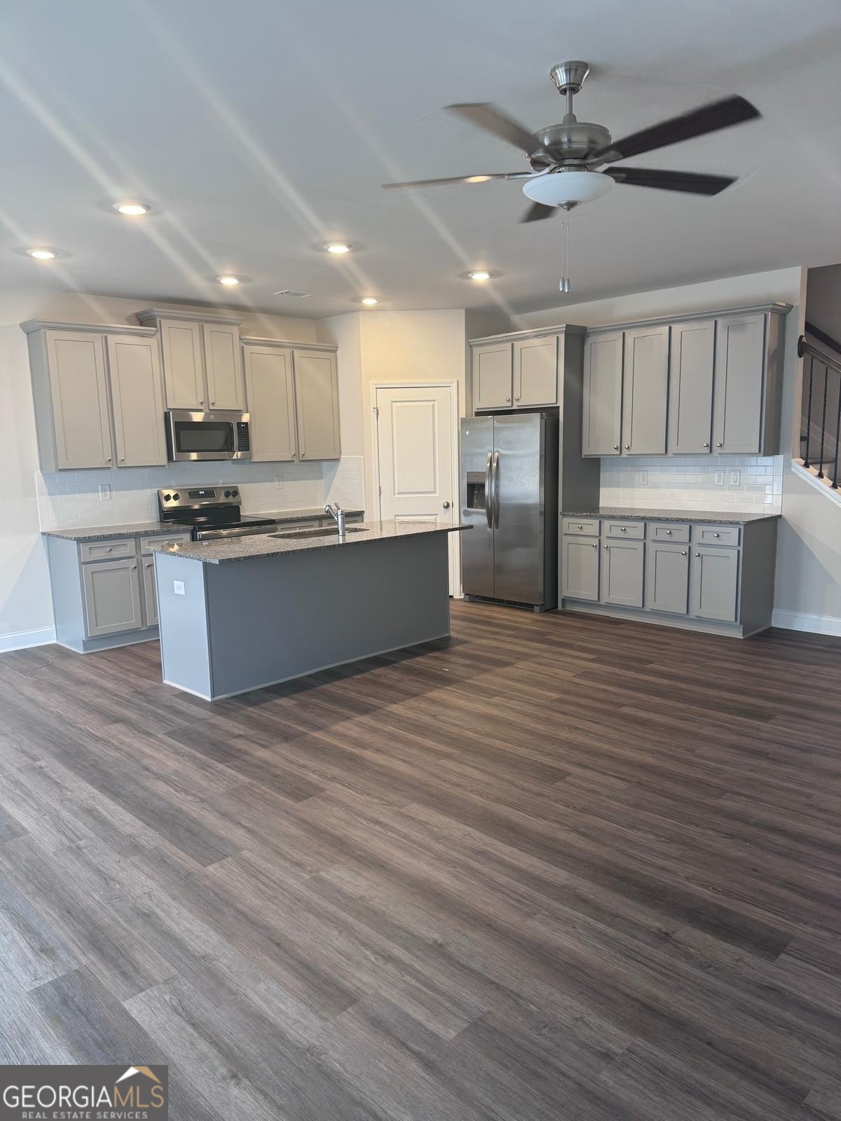 855 Pensive Run Dacula, GA 30019 - Photo 2 of 8 a kitchen with stainless steel appliances granite countertop a stove sink and cabinets