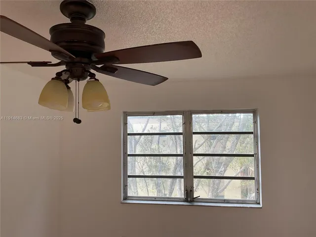 a lamp on a small kitchen next to a window