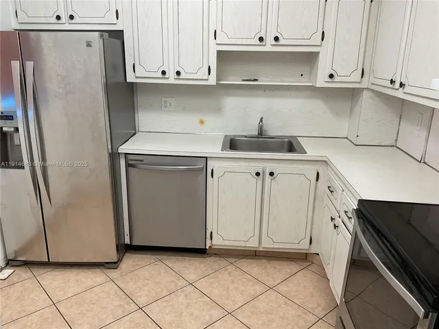 a kitchen with stainless steel appliances a refrigerator and a stove