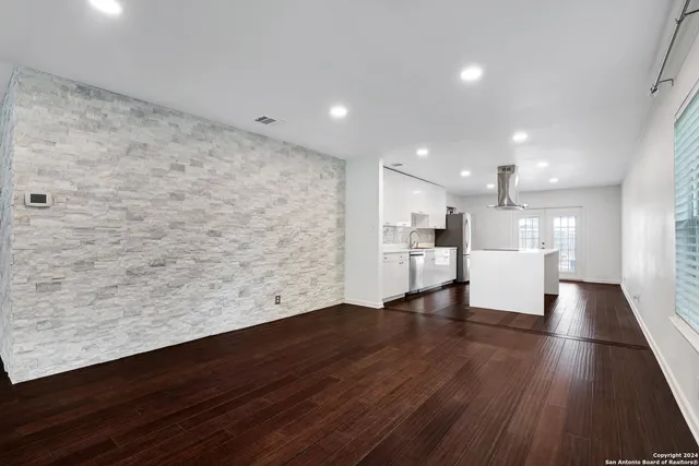a view of a kitchen with a sink and wooden floor