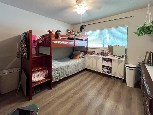 a bed room with a bed and a chair