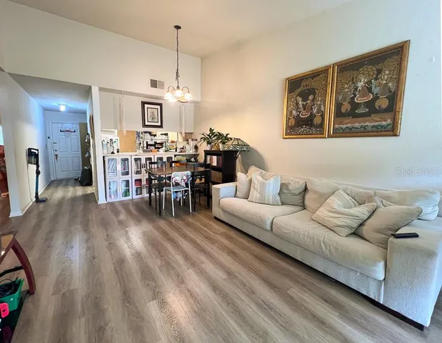 a living room with furniture and a chandelier