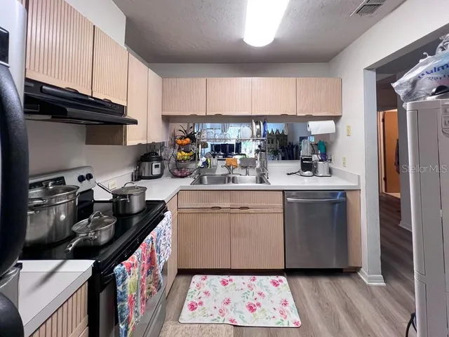 a kitchen with refrigerator and cabinets