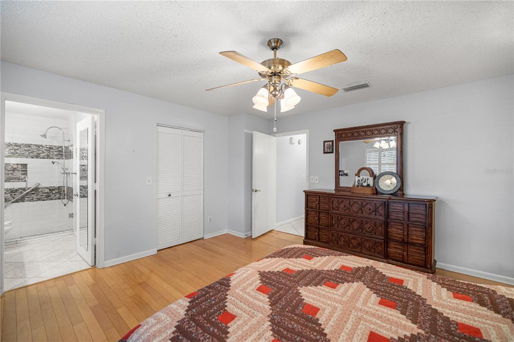 9438 Southwest 85th Avenue, Unit B Ocala, FL 34481 - Photo 11 of 32 a bedroom with a bed and a dresser