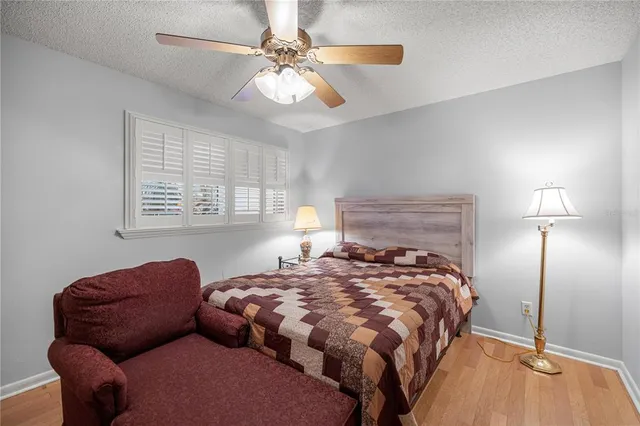 a bedroom with bed couch and window