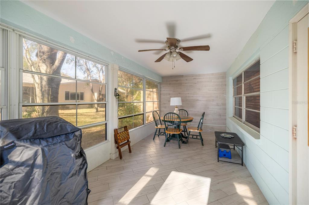 9438 Southwest 85th Avenue, Unit B Ocala, FL 34481 - Photo 18 of 32 a living room with furniture a fireplace and a floor to ceiling window