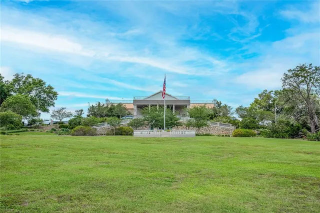 a view of a garden with a house in the background