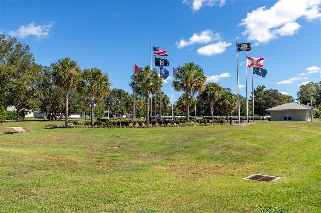 9438 Southwest 85th Avenue, Unit B Ocala, FL 34481 - Photo 32 of 32 a view of a fountain in front of a house with a big yard
