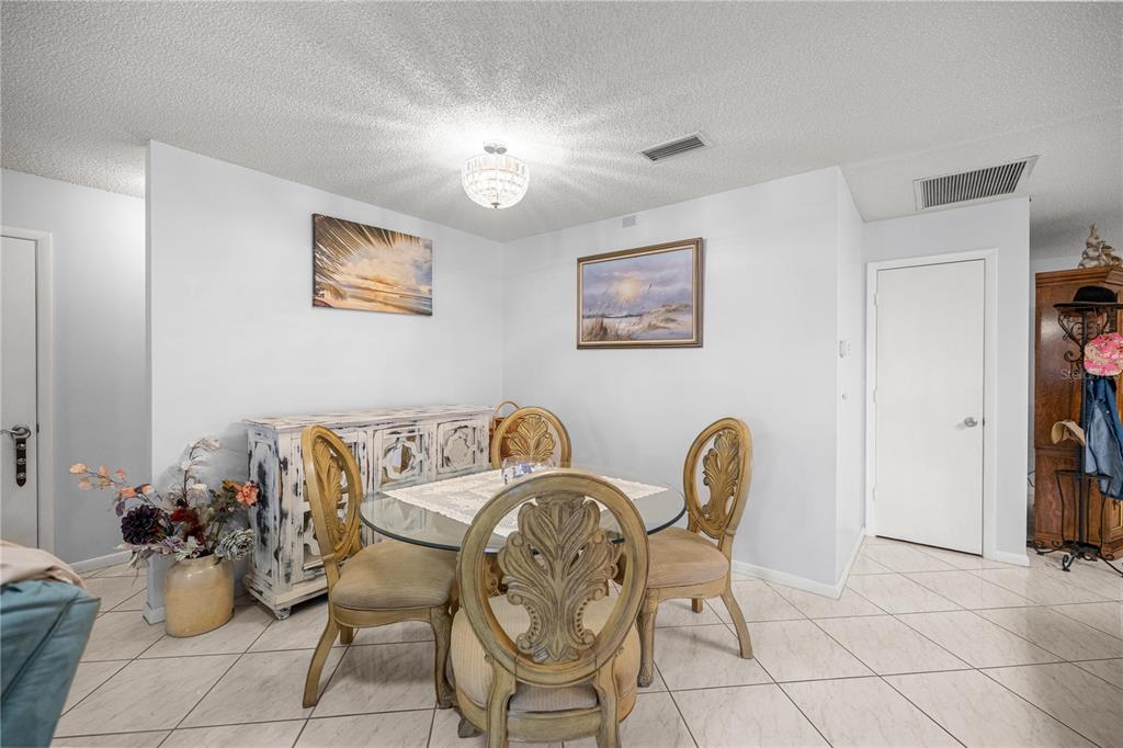 9438 Southwest 85th Avenue, Unit B Ocala, FL 34481 - Photo 4 of 32 a dining room with furniture and wooden floor