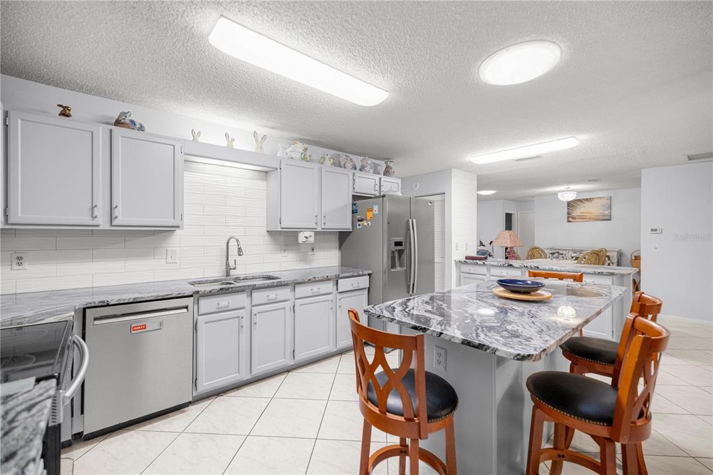 9438 Southwest 85th Avenue, Unit B Ocala, FL 34481 - Photo 6 of 32 a kitchen with refrigerator and cabinets