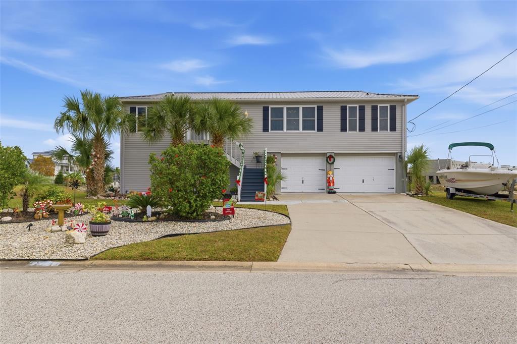 3366 Bluefish Drive Hernando Beach, FL 34607 - Photo 53 of 75 a view of a house with entertaining space and a car parked in front of it