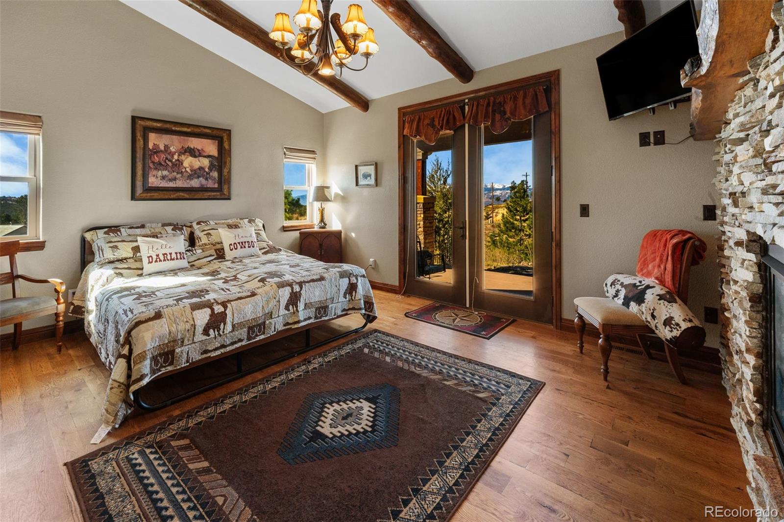 12875 Holmes Road Colorado Springs, CO 80908 - Photo 21 of 50 a bed sitting in a bedroom next to a window