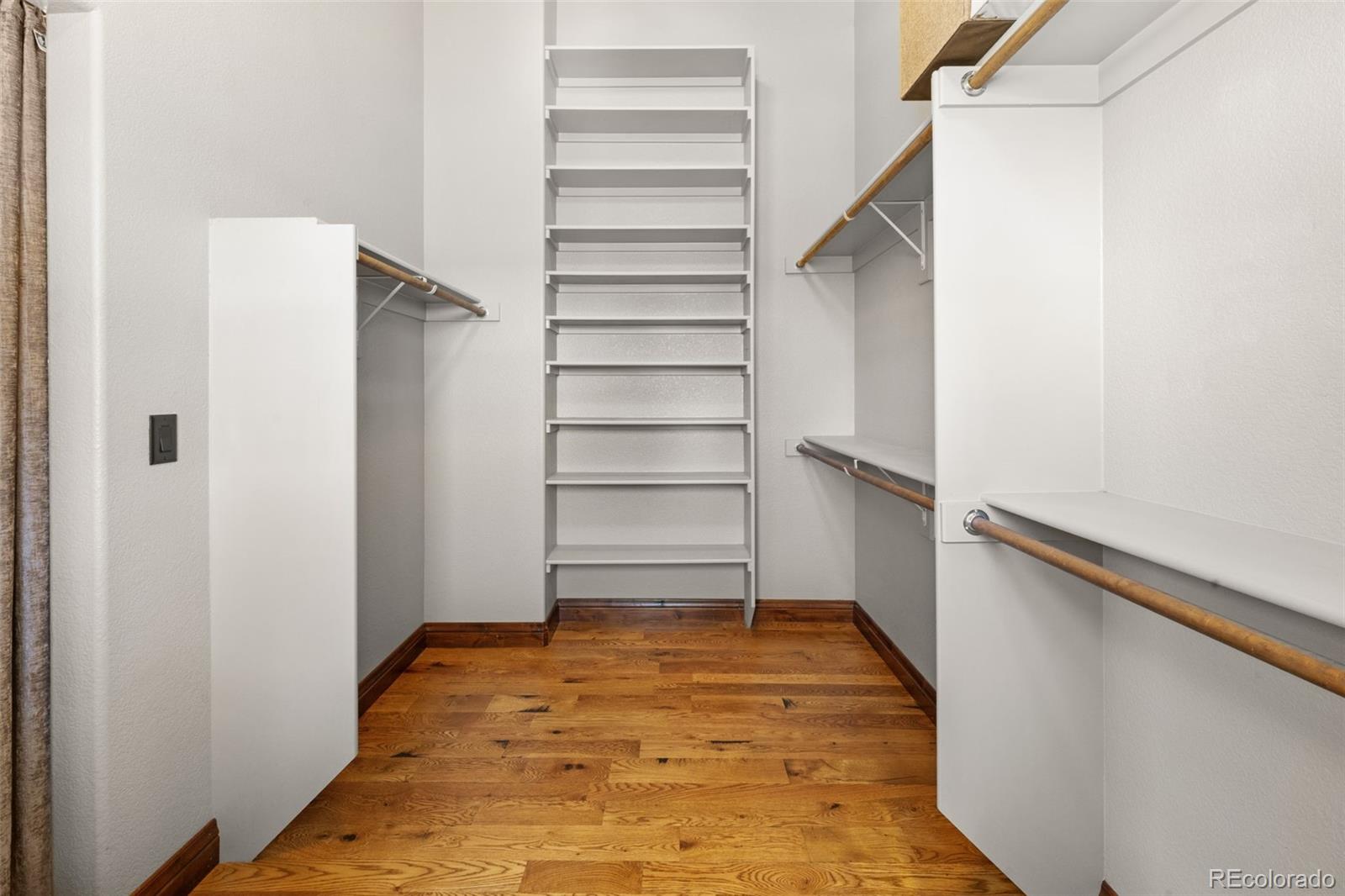 12875 Holmes Road Colorado Springs, CO 80908 - Photo 27 of 50 a view of walk in closet with empty racks