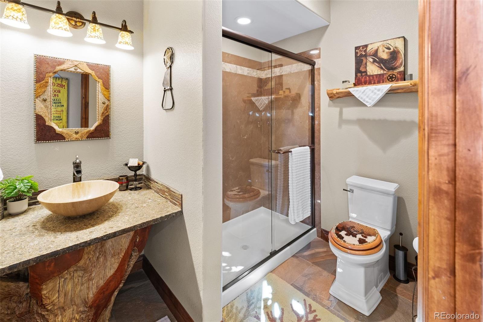 12875 Holmes Road Colorado Springs, CO 80908 - Photo 32 of 50 a bathroom with a granite countertop sink and a mirror
