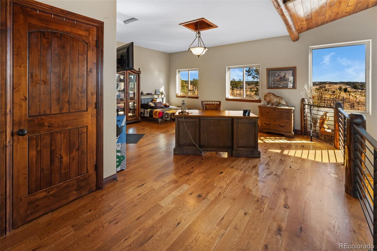 12875 Holmes Road Colorado Springs, CO 80908 - Photo 33 of 50 a living room with furniture and a wooden floor
