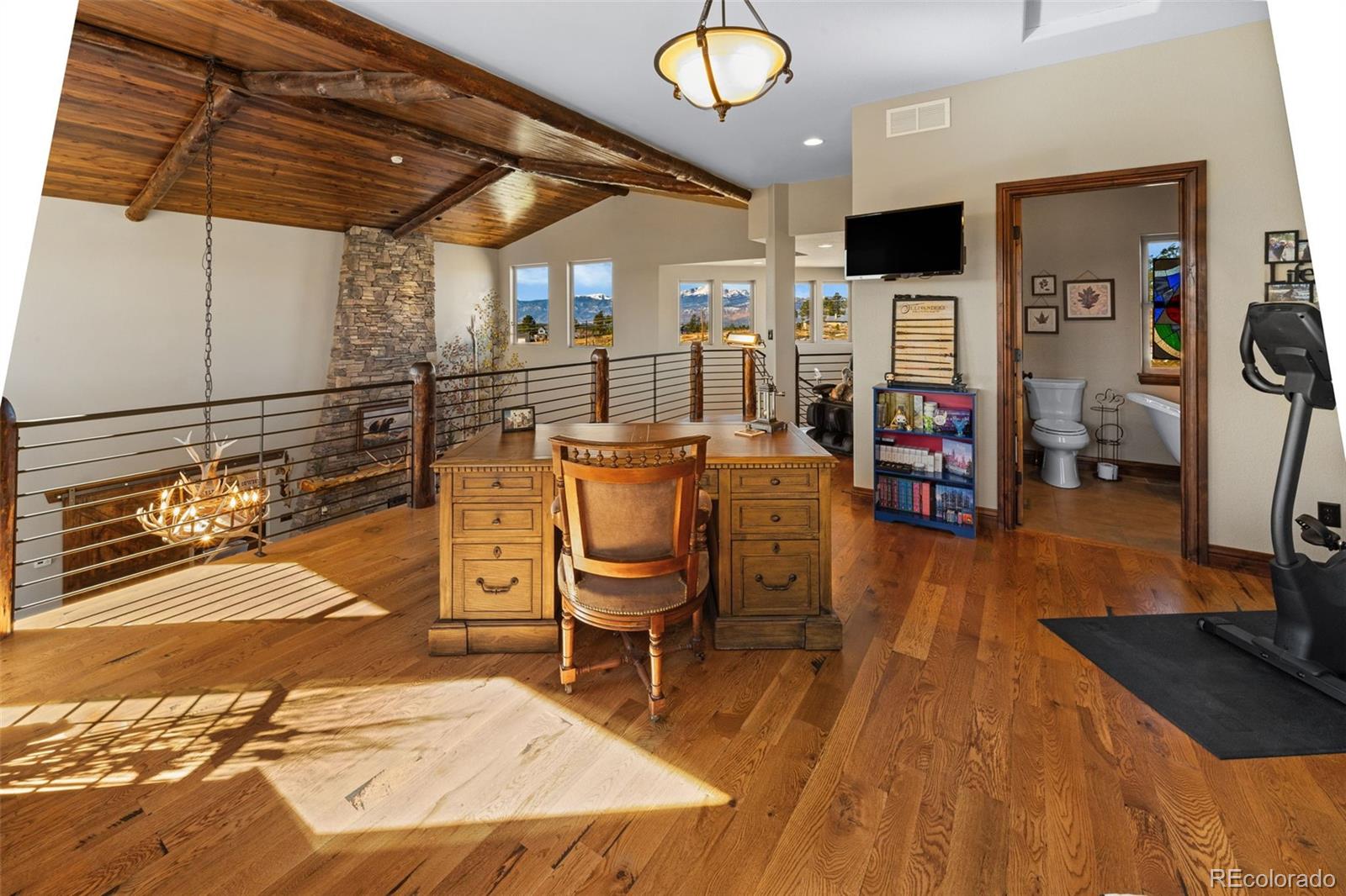 12875 Holmes Road Colorado Springs, CO 80908 - Photo 34 of 50 a living room filled with furniture and a flat screen tv
