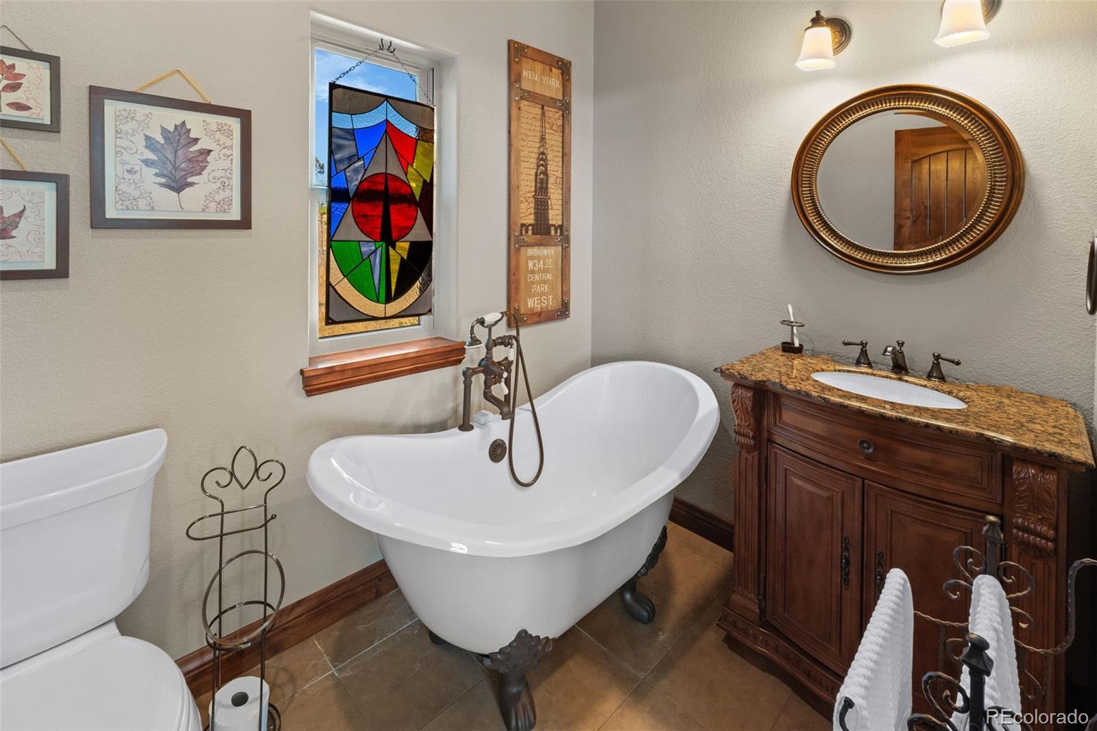12875 Holmes Road Colorado Springs, CO 80908 - Photo 35 of 50 a bathroom with a toilet a sink and a mirror