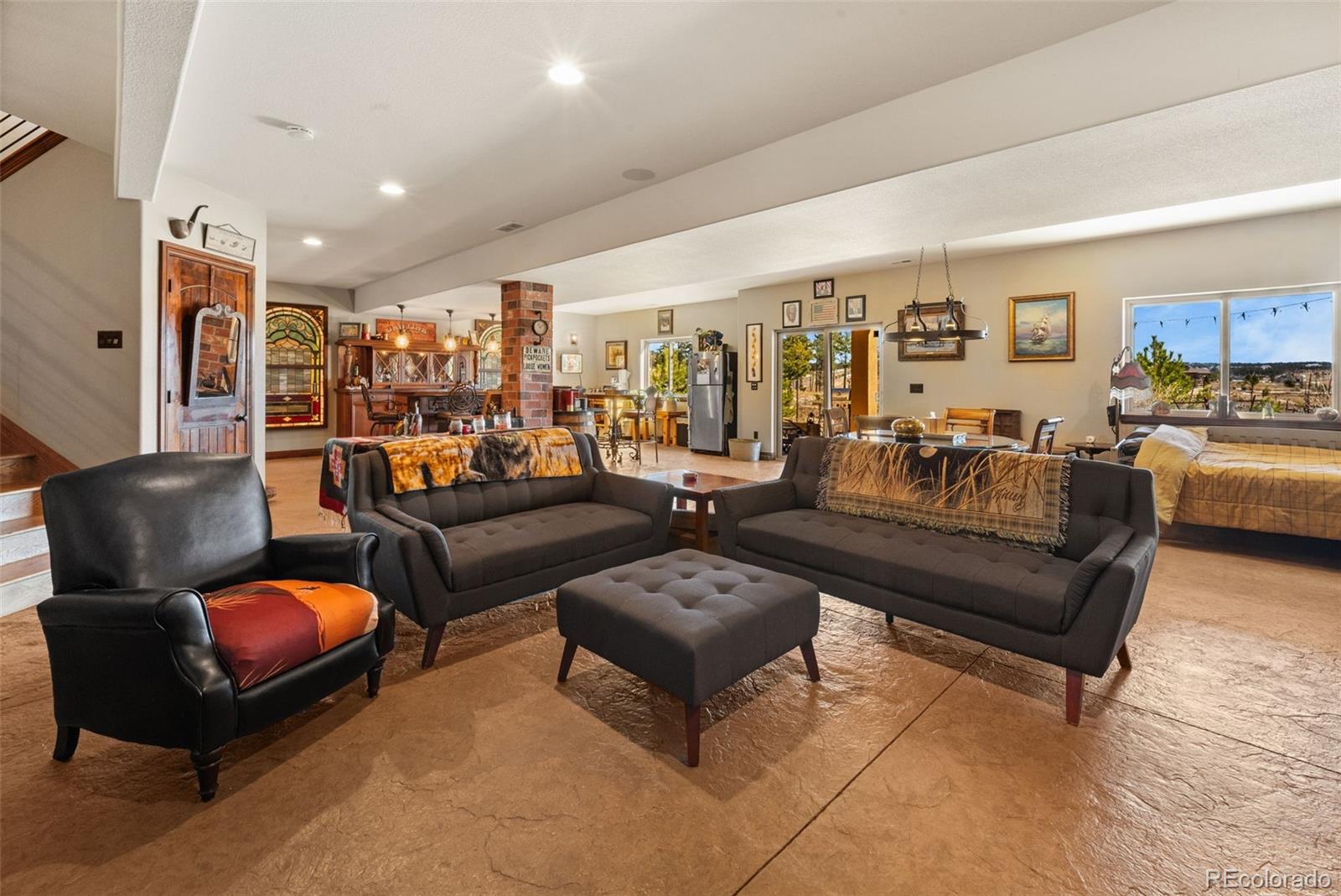 12875 Holmes Road Colorado Springs, CO 80908 - Photo 36 of 50 a living room with furniture a rug and a chandelier
