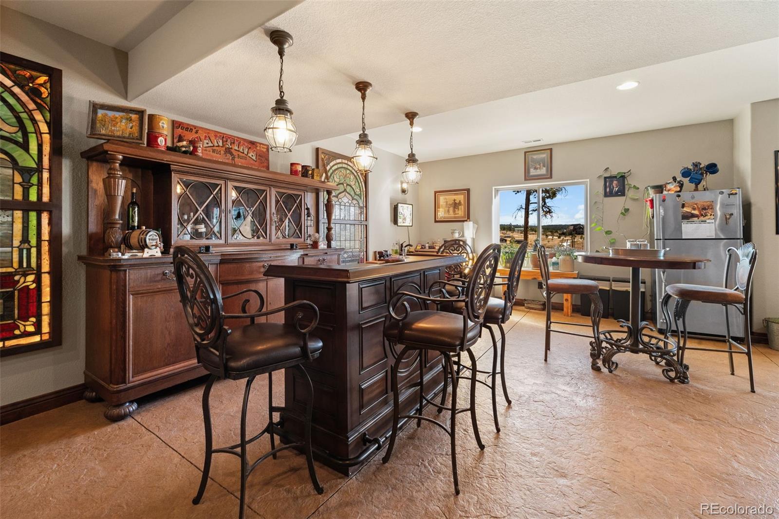 12875 Holmes Road Colorado Springs, CO 80908 - Photo 38 of 50 a view of a dining area with furniture window and wooden floor
