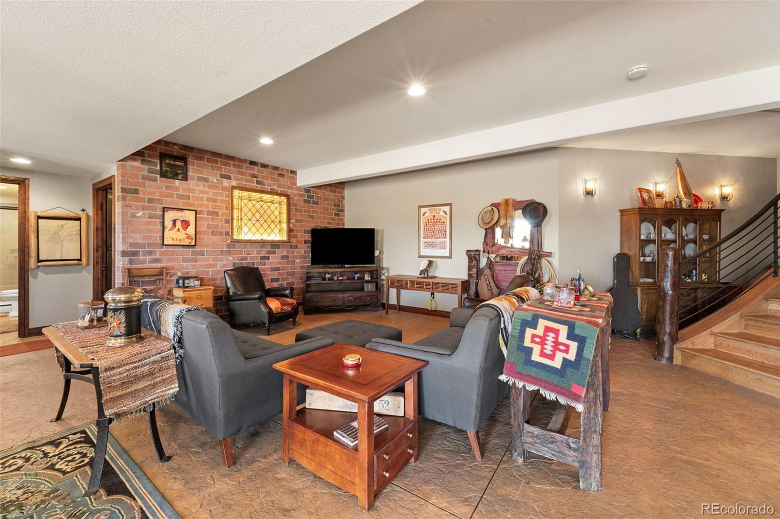 12875 Holmes Road Colorado Springs, CO 80908 - Photo 41 of 50 a living room with furniture a dining table and a flat screen tv