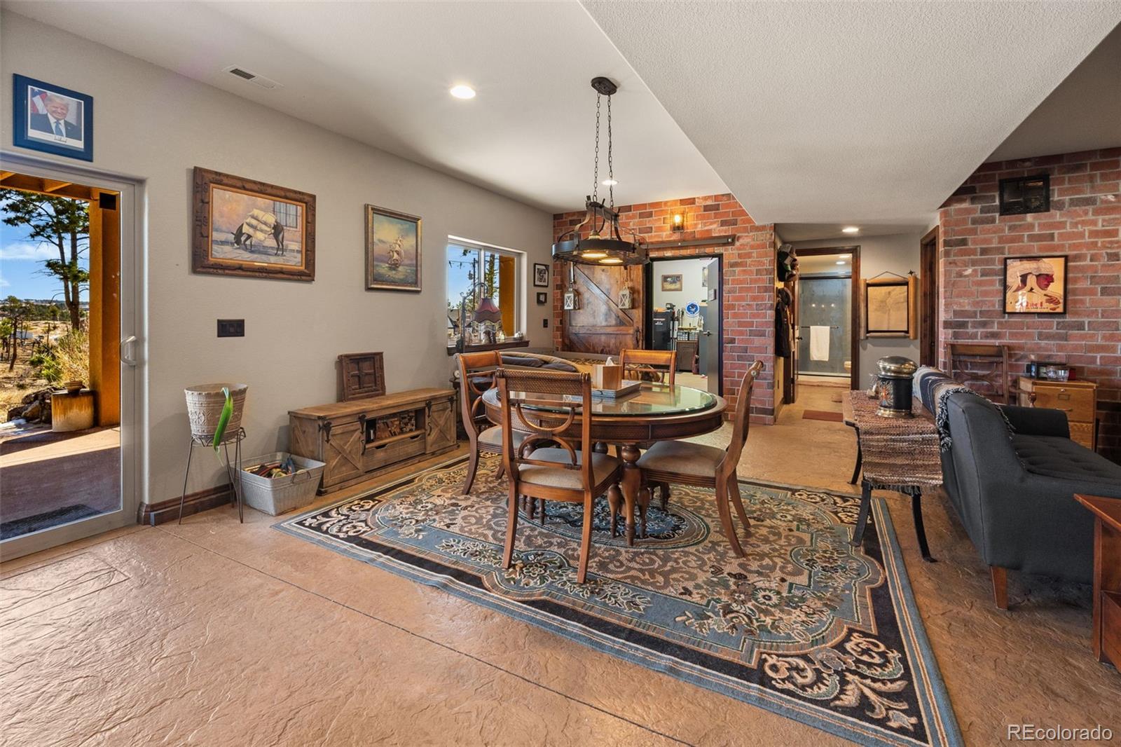 12875 Holmes Road Colorado Springs, CO 80908 - Photo 43 of 50 a dining room with wooden floor a table and chairs