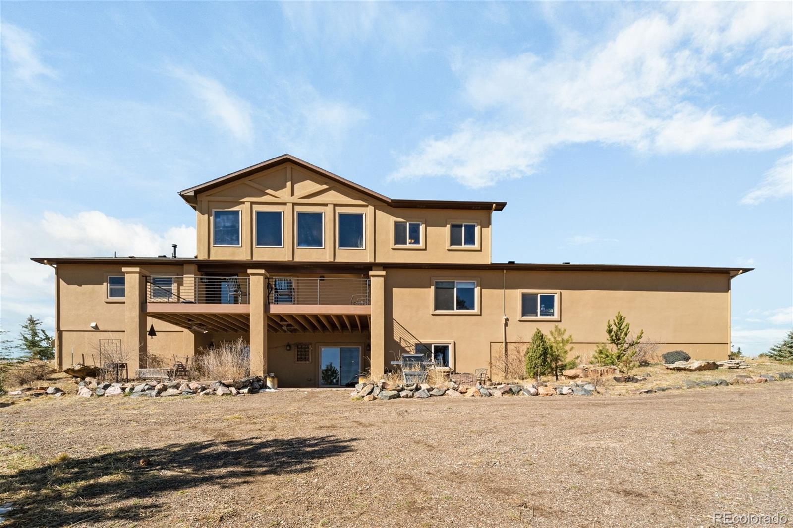 12875 Holmes Road Colorado Springs, CO 80908 - Photo 48 of 50 a front view of a house with a yard